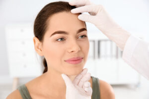 Woman having a consultation with her provider to choose between biostimulator vs. dermal filler injections