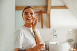 Smiling woman caring for skin in the days after her IPL Photofacial session
